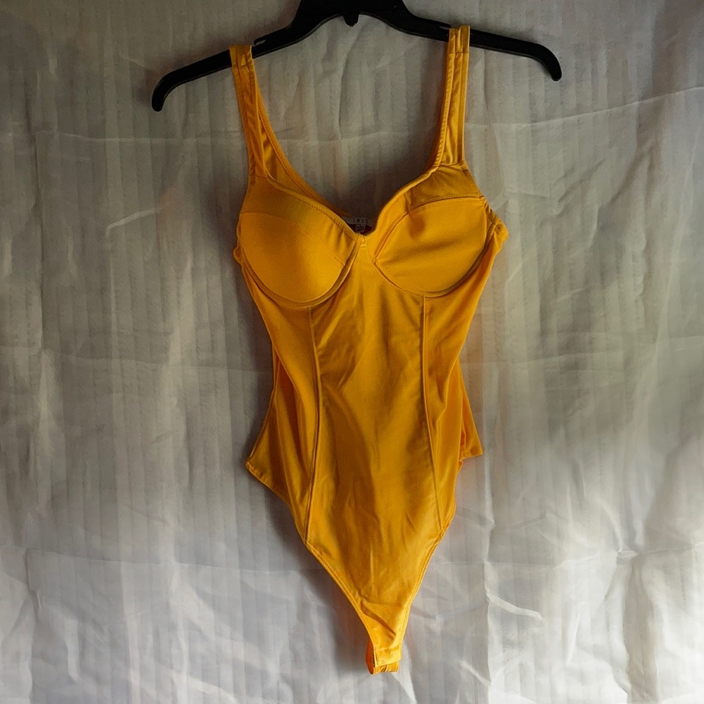 Yellow/orange kinda color Body suit size Large